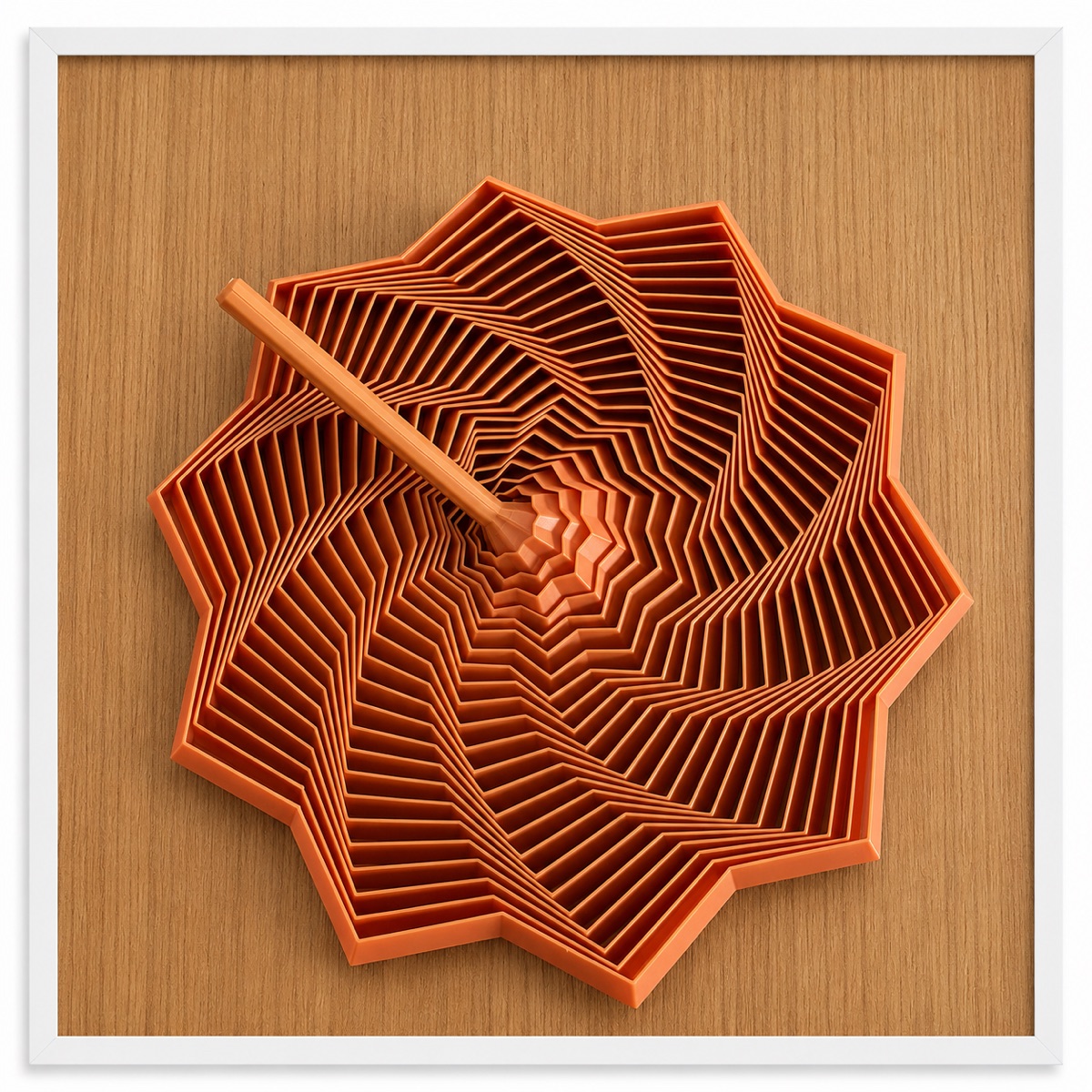 An orange sculptural spiral fidget in a white frame